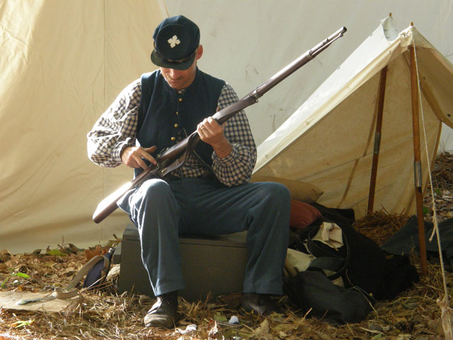 Rebel soldier loads his weapon for battle at Fort Branch