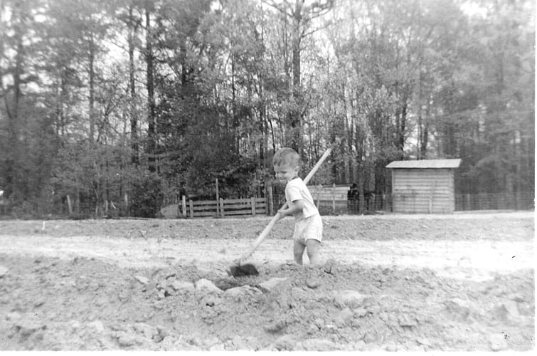 Monk Gurking planting tomatoes on the farm that is now Big Mill Bed and Breakfast